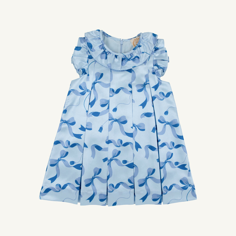 Introducing the Grandccasion™ Delaney Dinner Dress - Bagley Bows (Beale Street Blue) by The Beaufort Bonnet Company: a light blue sleeveless girls’ special occasion dress, featuring puffy shoulders, a ruffle collar, charming blue bow patterns, and elegant pleated details—an exquisite choice for any holiday party.