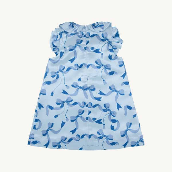 Introducing the Grandccasion™ Delaney Dinner Dress - Bagley Bows (Beale Street Blue) from The Beaufort Bonnet Company, a sleeveless girls’ special occasion dress featuring a ruffled collar and armholes, adorned with an all-over blue bow pattern. With its soft, glossy finish and elegant A-line silhouette, this dress is the perfect choice for holiday parties.