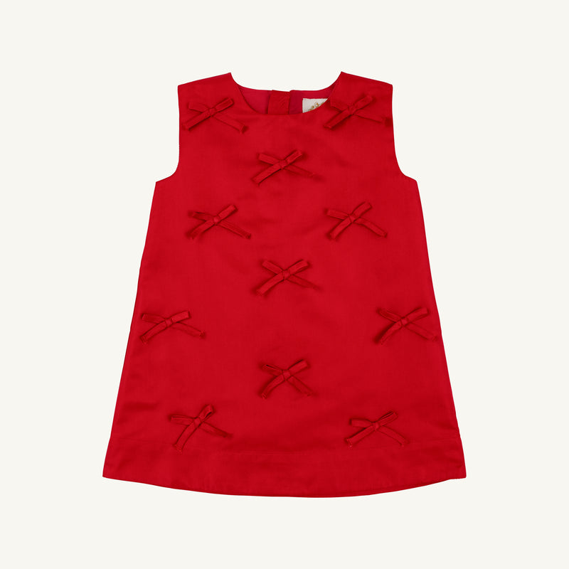 Sleeveless Grandccasion™ Jilly Jumper in Richmond Red Taffeta from The Beaufort Bonnet Company, featuring a simple A-line silhouette adorned with multiple small red fabric bows on the front. Set against a plain white background, this girls’ special occasion dress stands out beautifully.