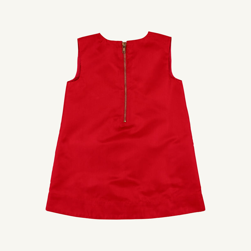 The Beaufort Bonnet Company’s Grandccasion™ Jilly Jumper in Richmond Red Taffeta, a sleeveless girls’ special occasion dress with an elegant design and a visible gold zipper on the back, is shown against a simple light background.