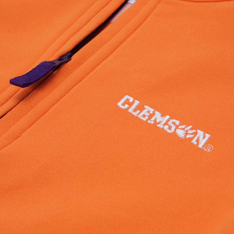 Close-up of The Beaufort Bonnet Company’s Clemson Hayword Half-Zip in Clemson Orange with Clemson Regalia and Worth Avenue White, featuring a zipper and an embroidered white logo with a tiger paw as the “O” in Clemson—perfect for game day layering.