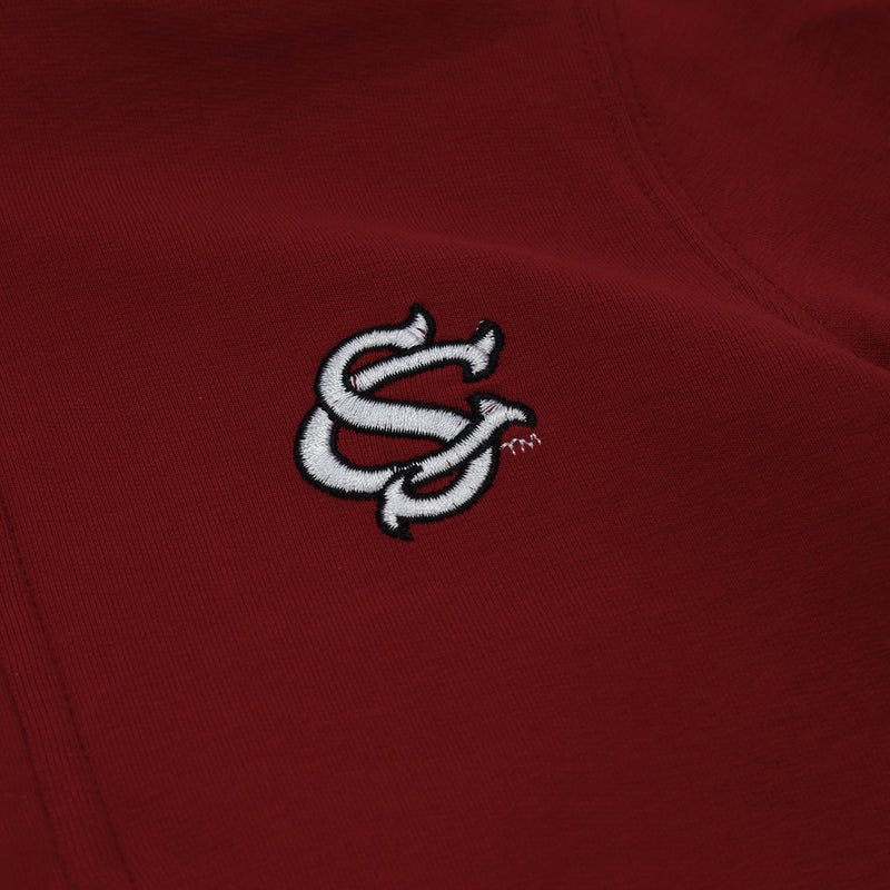 A close-up of the USC Hayword Half-Zip by The Beaufort Bonnet Company in South Carolina Burgundy with Worth Avenue White, featuring an embroidered white interlocking SC logo that captures classic Gamecock style and the rich tone of this signature shade.