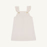 The Julia Jumper by The Beaufort Bonnet Company, shown laid flat on a white background, is a sleeveless pink corduroy dress featuring Richmond Red and Palmetto Pearl microdot polka dots, ruffled shoulder straps, and button details at the front.