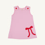 Introducing the Juliet Jumper - Pier Party Pink with Richmond Red Bow by The Beaufort Bonnet Company, a sleeveless toddler dress crafted from soft Pima Cotton Knit. This festive Christmas dress features two pink buttons on the shoulders and a charming Richmond Red bow on the lower right side.