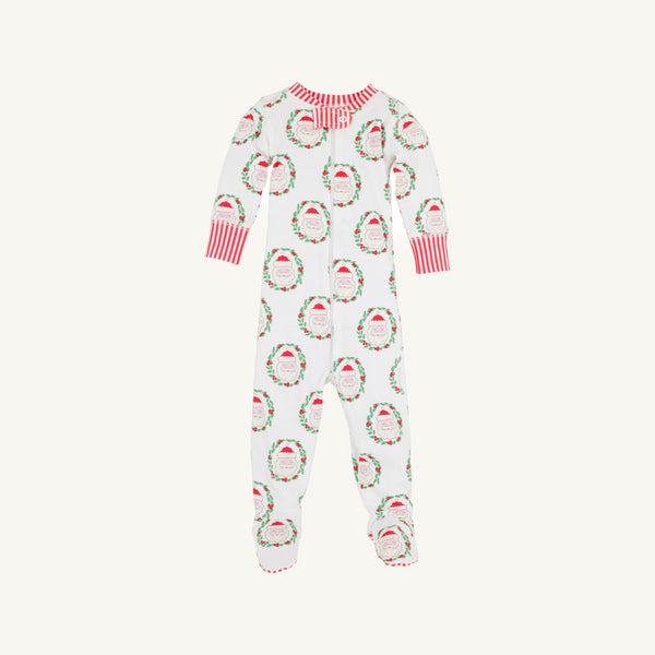 The Beaufort Bonnet Company’s Knox’s Night Night - North Pole Portrait with Richmond Red Stripe is a white baby onesie adorned with a cheerful pattern of red and green Santa Claus faces and wreaths, finished with red-and-white striped cuffs and collar, displayed on a plain background.