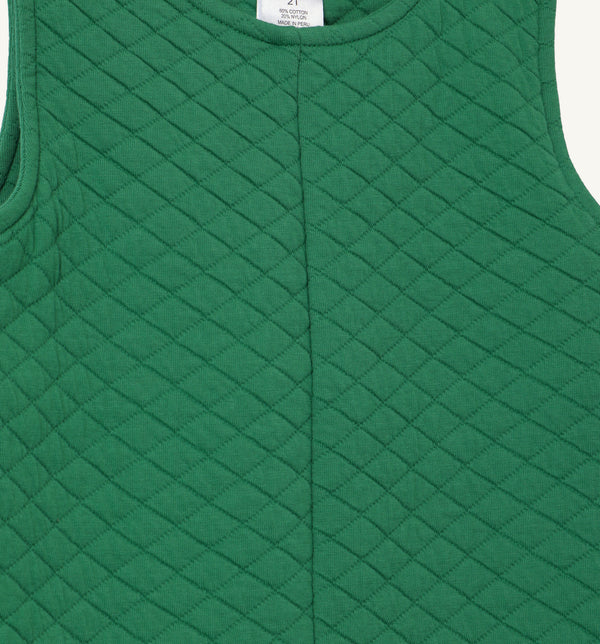 Close-up of The Beaufort Bonnet Company’s Lawson Longall in Kiawah Kelly Green Quilted fabric. This sleeveless one-piece features a diamond pattern with a soft, textured feel and a visible vertical seam down the center.
