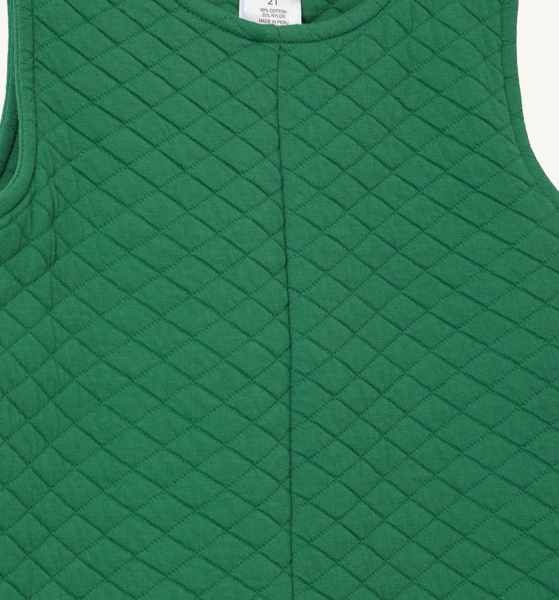 Close-up of The Beaufort Bonnet Company’s Lawson Longall in Kiawah Kelly Green Quilted fabric. This sleeveless one-piece features a diamond pattern with a soft, textured feel and a visible vertical seam down the center.