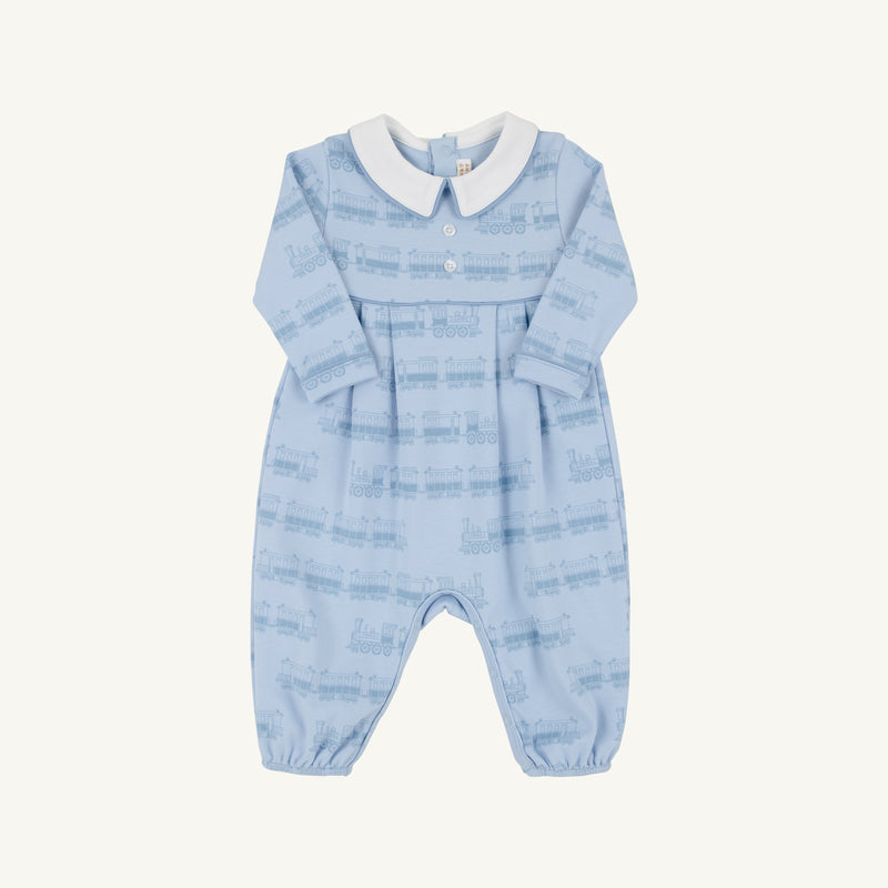 The Beaufort Bonnet Company’s Long Sleeve Bradford Romper - Blue Choo Choos with Worth Avenue White features a light blue design with a crisp white collar, charming chest buttons, and a subtle Blue Choo Choos train pattern. Expertly crafted from super-soft Pima Cotton, this romper combines comfort and timeless style.
