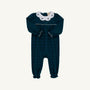 The Beaufort Bonnet Company’s Long Sleeve Britt Romper in Woodlake Point Plaid with Worth Avenue White showcases a timeless dark green and blue plaid, complemented by a crisp white Peter Pan collar adorned with delicate blue bows. Charming ruffled edges at the cuffs and ankles add classic flair—making it a perfect piece for enhancing your little one’s autumn wardrobe.