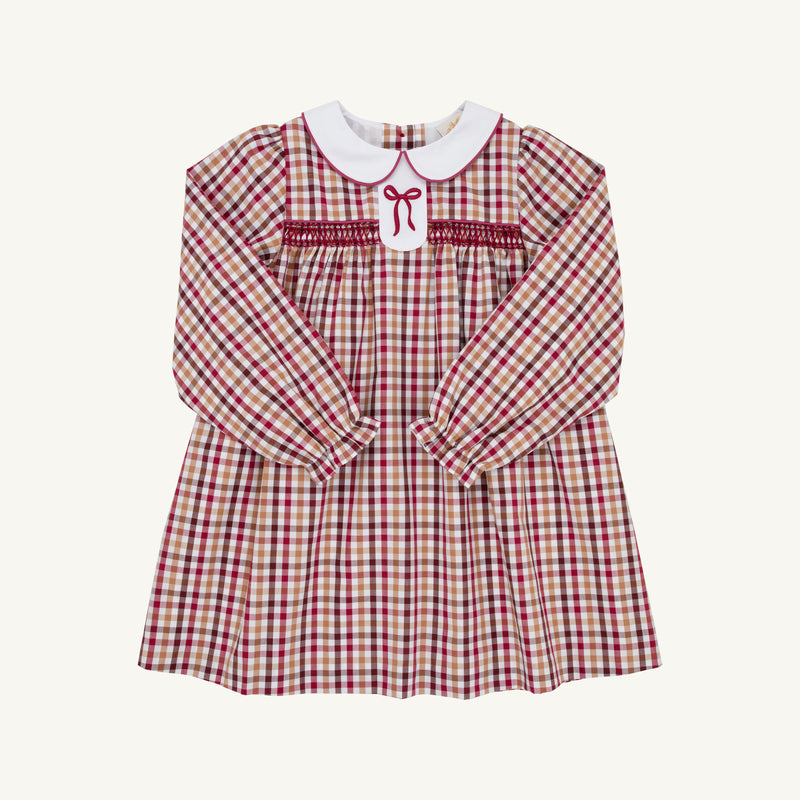 The Beaufort Bonnet Company’s Long Sleeve Mary Dal Dress - Easton Pond Plaid with Worth Avenue White features red and beige plaid, a classic white Peter Pan collar, smocked chest, and delicate red embroidered bow detail on the front—making it the perfect autumn dress for girls.