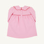 The Beaufort Bonnet Company’s Long Sleeve Maude’s Day Dress in Pier Party Pink with Richmond Red is a baby dress crafted from 100% Pima Cotton, featuring a scalloped collar, red trim, button closures on the upper back, and gentle gathering below the yoke.