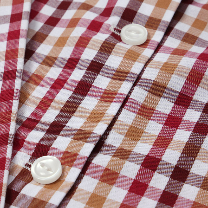 Close-up of The Beaufort Bonnet Company’s Long Sleeve Peter Pan Collar Shirt & Onesie - Easton Pond Plaid, featuring a red, white, and beige checkered pattern with two white buttons.