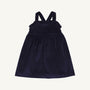A child’s Macy Drew Dress in Nantucket Navy Corduroy by The Beaufort Bonnet Company, featuring a sleeveless design with ruffled detailing at the neckline and crossed back straps, shown on a plain white background. A perfect addition to any fall wardrobe.