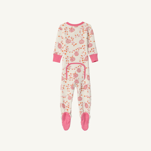 The Beaufort Bonnet Company’s Noelle’s Night Night - Gourd-geous (Palmetto Pearl) with Palm Beach Pink is a cozy waffle knit one-piece girls’ pajama laid flat on a white background. These white footed pajamas feature pink cuffs, matching pink soles, an all-over pink pomegranate-inspired print, and a pink-trimmed flap on the back.