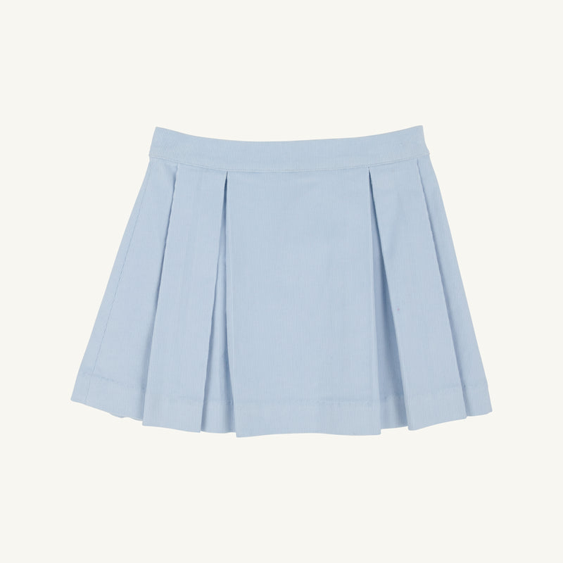 The Parson Pleated Skirt - Buckhead Blue Corduroy by The Beaufort Bonnet Company is displayed on a plain, light background. This girls’ Christmas skirt showcases a wide waistband and evenly spaced pleats in a charming light blue corduroy, offering a timeless and classic look.