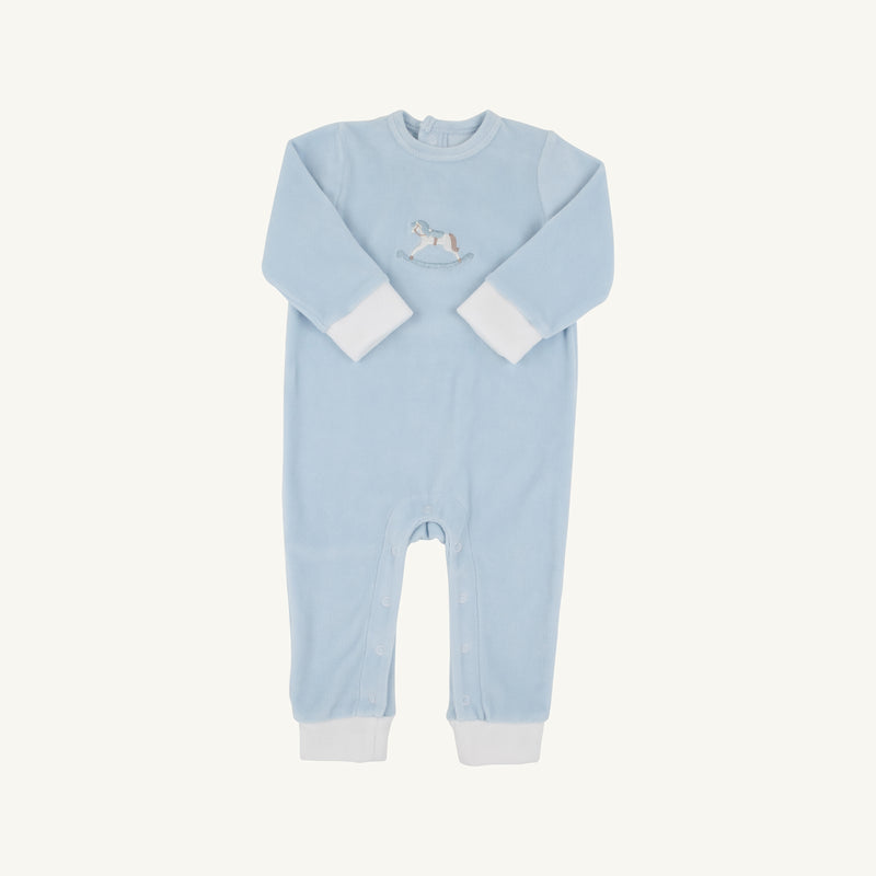 The Beaufort Bonnet Company’s Paxton Playsuit in Buckhead Blue features long sleeves, white cuffs and ankle bands, and an embroidered rocking horse on the chest. Designed for easy changing, it includes snap closures along the legs.