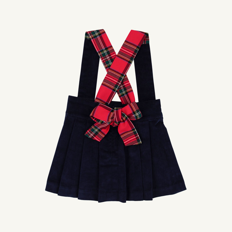 Pearl Prep Skirt in navy blue Nantucket corduroy, featuring crisscrossed Society Prep plaid suspender straps and a large matching bow at the waist.