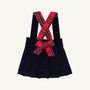 Pearl Prep Skirt in navy blue Nantucket corduroy, featuring crisscrossed Society Prep plaid suspender straps and a large matching bow at the waist.