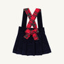 Pearl Prep Skirt in navy blue Nantucket corduroy, featuring crisscrossed Society Prep plaid suspender straps and a large matching bow at the waist.