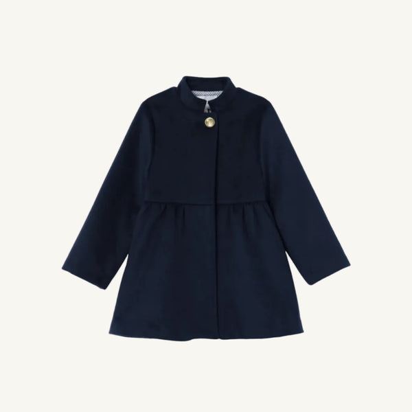 The Penelope Peacoat - Nantucket Navy by The Beaufort Bonnet Company is a girls’ peacoat with long sleeves, a single gold button at the collar, and a flared skirt. This simple and elegant design is displayed on a plain white background.