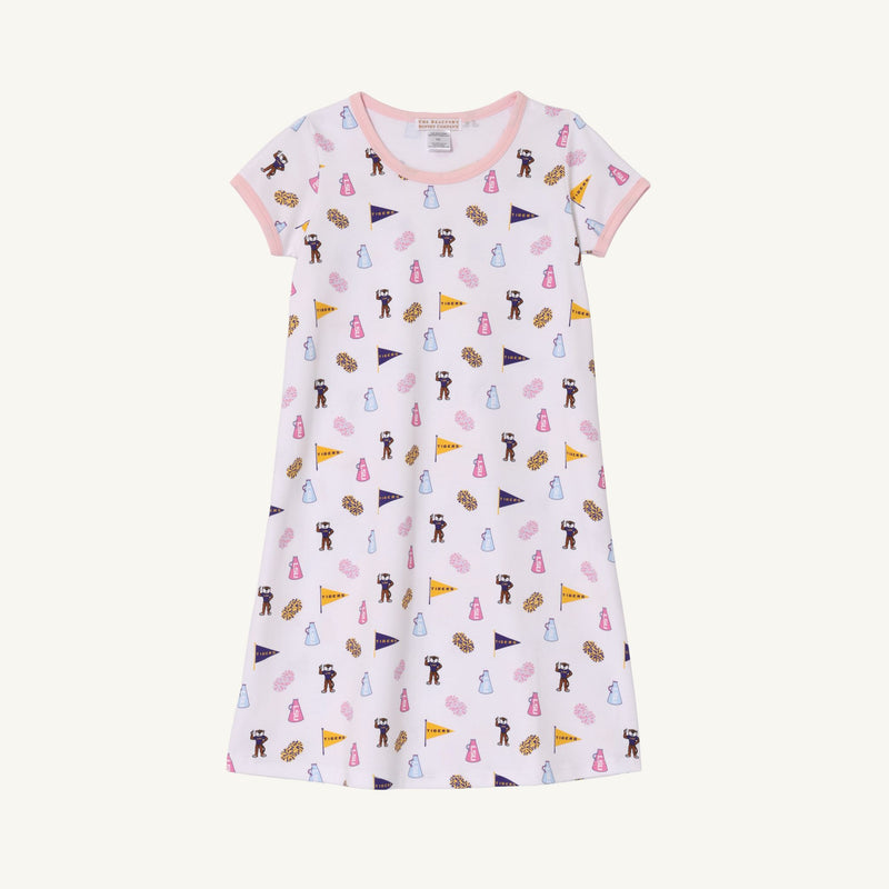 The LSU Polly Play Dress - Tenacious Tigers with Palm Beach Pink by The Beaufort Bonnet Company is a short-sleeved, light pink children’s dress made from soft Pima Cotton Knit, featuring all-over prints of pennants, teddy bears, and milk bottles in various colors, and finished with pink trim on the collar and sleeves.