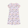 The LSU Polly Play Dress - Tenacious Tigers with Palm Beach Pink by The Beaufort Bonnet Company is a short-sleeved, light pink children’s dress made from soft Pima Cotton Knit, featuring all-over prints of pennants, teddy bears, and milk bottles in various colors, and finished with pink trim on the collar and sleeves.