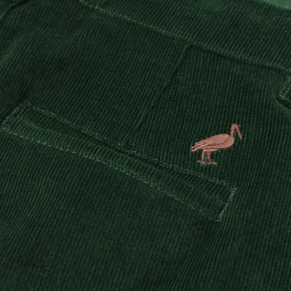 Close-up of a dark green corduroy pocket from The Beaufort Bonnet Company’s Prep School Pants in Grier Green, featuring a small embroidered Gray Bay Brown stork logo above the pocket.