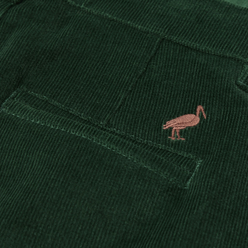 Close-up of a dark green corduroy pocket from The Beaufort Bonnet Company’s Prep School Pants in Grier Green, featuring a small embroidered Gray Bay Brown stork logo above the pocket.