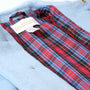 A close-up of a Barrington Blue Price Bell Peacoat with a red and blue plaid lining. A fabric label inside reads The Beaufort Bonnet Company.