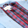 A close-up of a Barrington Blue Price Bell Peacoat with a red and blue plaid lining. A fabric label inside reads The Beaufort Bonnet Company.