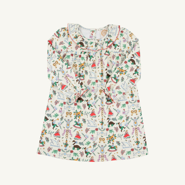 The Beaufort Bonnet Company’s Long Sleeve Ramona Ruffle Dress - 12 Days of Christmas is a white children’s dress crafted from soft Pima Cotton Knit, featuring long sleeves and a charming ruffled collar. Adorned with a colorful print of birds, animals, mushrooms, plants, and other whimsical motifs inspired by the holiday season, it’s perfect for festive occasions like the 12 Days of Christmas.