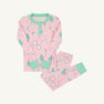 Sara Jane’s Sweet Dream Set - Mrs. Claus Collage with Grace Bay Green by The Beaufort Bonnet Company is a pink long-sleeve Christmas pajama set with green cuffs and collar, adorned with festive prints such as wreaths, presents, and Santa Claus, laid flat on a white background.