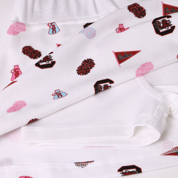 Show your South Carolina Spirit with The Beaufort Bonnet Company’s USC Searcy Skort - South Carolina Spirit with Worth Avenue White, featuring white fabric adorned with University of South Carolina logos, cheer megaphones, pom-poms, and red and garnet Carolina flags in overlapping layers. Perfect for custom creations or spirited game day style!.