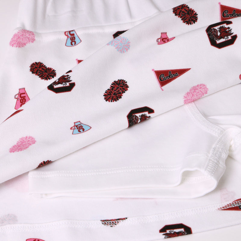 Show your South Carolina Spirit with The Beaufort Bonnet Company’s USC Searcy Skort - South Carolina Spirit with Worth Avenue White, featuring white fabric adorned with University of South Carolina logos, cheer megaphones, pom-poms, and red and garnet Carolina flags in overlapping layers. Perfect for custom creations or spirited game day style!.