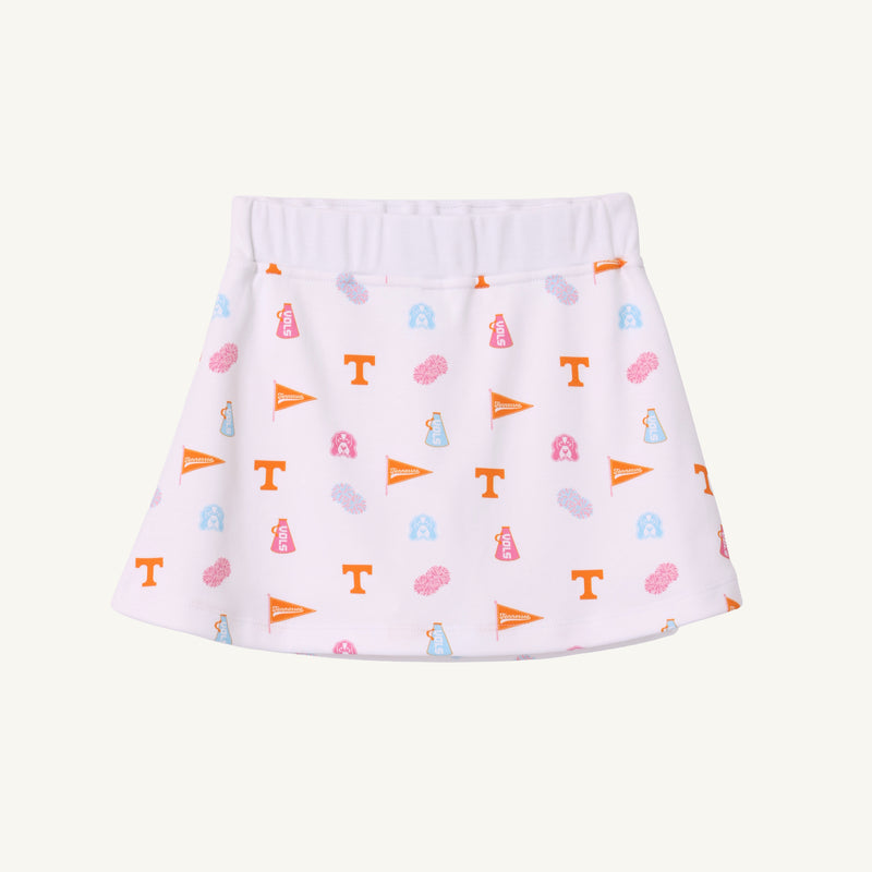 The Tennessee Searcy Skort - Victory in Orange with Worth Avenue White by The Beaufort Bonnet Company features a white background adorned with orange, blue, and pink University of Tennessee-themed icons—including T logos, pennants, pom-poms, and megaphones—making it the perfect choice for your next gameday outfit.
