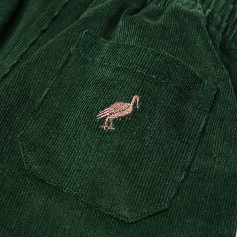 Close-up of The Beaufort Bonnet Company’s Sheffield Pants in Grier Green corduroy, featuring a stitched Gray Bay Brown stork on the pocket—perfect for fall activities.