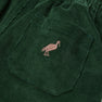 Close-up of The Beaufort Bonnet Company’s Sheffield Pants in Grier Green corduroy, featuring a stitched Gray Bay Brown stork on the pocket—perfect for fall activities.