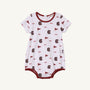 The Beaufort Bonnet Company’s USC Short Sleeve Patton Play Bubble - South Carolina Spirit with South Carolina Burgundy is a white baby romper featuring maroon trim, USC text, pennant flags, and stylized letter C logos in maroon. Crafted from soft Pima cotton, this short sleeve bubble includes snaps at the bottom for easy diaper changes—perfect for showing your South Carolina spirit.