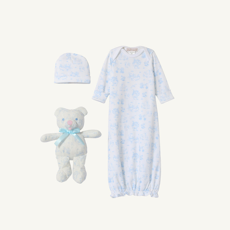 Introducing Sir Proper’s Sweet Arrival (Beale Street Blue) Bundle by The Beaufort Bonnet Company—an adorable everyday set featuring a white layette gown adorned with blue animal prints, a matching hat, and the cuddly Bradley Bear with a blue ribbon. The perfect baby shower gift!.