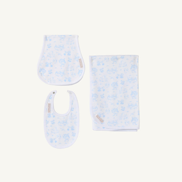 The Beaufort Bonnet Company’s Sir Proper’s Sweet Arrival (Beale Street Blue) Accessories Bundle is pictured, featuring a Baby Buggy Blanket, Oopsie Daisy Burp Cloth, and Burp Me Bib—all crafted in soft white fabric with a light blue animal print pattern and arranged on a white background. This charming set makes an ideal choice for baby shower gifts or to add to your baby registry.