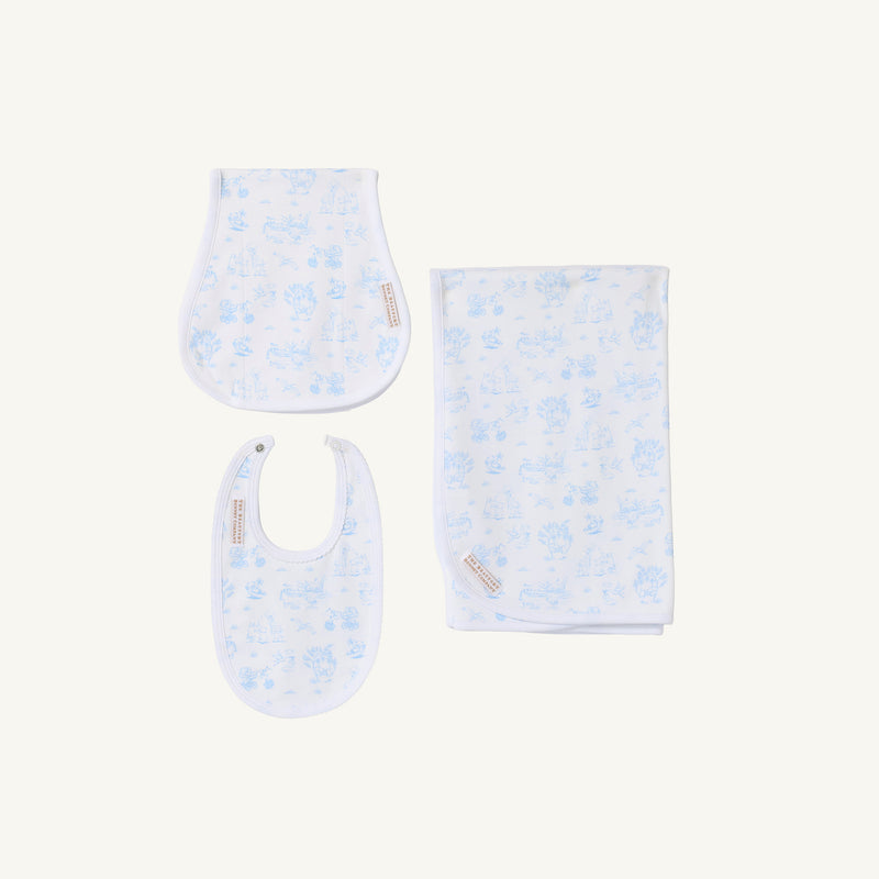 The Beaufort Bonnet Company’s Sir Proper’s Sweet Arrival (Beale Street Blue) Accessories Bundle is pictured, featuring a Baby Buggy Blanket, Oopsie Daisy Burp Cloth, and Burp Me Bib—all crafted in soft white fabric with a light blue animal print pattern and arranged on a white background. This charming set makes an ideal choice for baby shower gifts or to add to your baby registry.