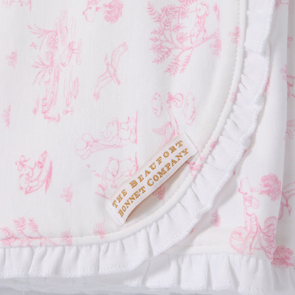 Crafted from soft pima cotton, the Sir Proper’s Sweet Arrival (Hamptons Hot Pink) Accessories Bundle by The Beaufort Bonnet Company features a white fabric adorned with pink, vintage-inspired illustrations and delicate ruffled edges. A beige and gold label reading THE BEAUFORT BONNET COMPANY is sewn onto each piece. This charming set—including a Baby Buggy Blanket, Oopsie Daisy Burp Cloth, and Burp Me Bib—makes a thoughtful baby shower gift.