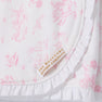 Crafted from soft pima cotton, the Sir Proper’s Sweet Arrival (Hamptons Hot Pink) Accessories Bundle by The Beaufort Bonnet Company features a white fabric adorned with pink, vintage-inspired illustrations and delicate ruffled edges. A beige and gold label reading THE BEAUFORT BONNET COMPANY is sewn onto each piece. This charming set—including a Baby Buggy Blanket, Oopsie Daisy Burp Cloth, and Burp Me Bib—makes a thoughtful baby shower gift.