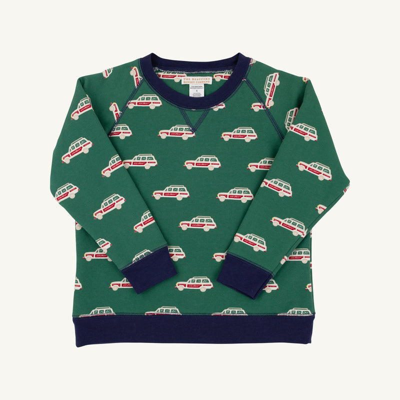 The Smitty Sweatshirt - Windsor Wagon (Grier Green) with Nantucket Navy by The Beaufort Bonnet Company is a green boys’ sweatshirt adorned with a red and white station wagon pattern, featuring navy blue collar, cuffs, and hem, plus a cozy fleece interior. The sweatshirt is shown laid flat on a white background.