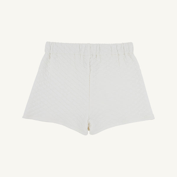 The Stella Skort - Quilted Palmetto Pearl by The Beaufort Bonnet Company is displayed flat on a plain background. These girls’ skirt shorts feature a textured, diamond-patterned quilted fabric, an elastic waistband, and a relaxed fit.
