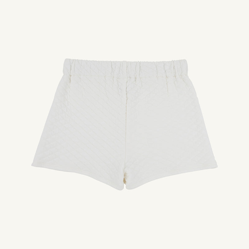 The Stella Skort - Quilted Palmetto Pearl by The Beaufort Bonnet Company is displayed flat on a plain background. These girls’ skirt shorts feature a textured, diamond-patterned quilted fabric, an elastic waistband, and a relaxed fit.