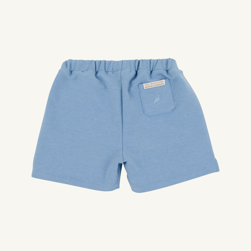 Sullivan Shorts - Barrington Blue Heathered by The Beaufort Bonnet Company feature an elastic waistband, a small back pocket on the right side, and a label above the pocket. These boys’ heathered shorts are shown on a plain white background.