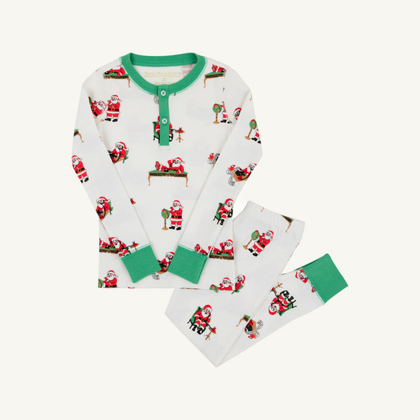 Sutton’s Sweet Dream Set – Serious Santa Business by The Beaufort Bonnet Company is a children’s white Pima cotton pajama set featuring green cuffs and collar, adorned with playful illustrations of Santa Claus in various poses. This festive holiday sleepwear includes a long-sleeve top and matching long pants, shown flat on a light background—perfect Christmas pajamas for kids.