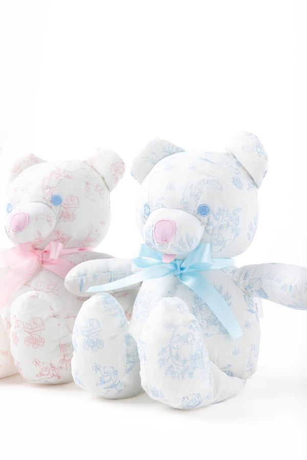 Two plush stuffed bears from The Beaufort Bonnet Company sit side by side against a white backdrop. One is the Bradley Bear, featuring charming blue accents and a blue ribbon, while the other boasts lovely pink details and a matching ribbon—making Sir Proper’s Sweet Arrival (Beale Street Blue) Bundle an ideal baby shower gift.
