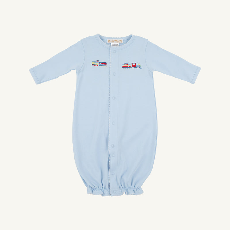 Introducing the Twinkle Twinkle 2-in-1—Buckhead Blue with Trains by The Beaufort Bonnet Company. Crafted from soft Pima cotton, this charming layette features a light blue hue, long sleeves, front snap buttons, and an elasticized bottom for easy changing. A delicate embroidered train motif spans the chest, adding a touch of classic charm. Perfect for your little one—all set against a plain white background.
